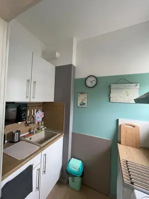 a kitchen with a sink and a clock on the wall at BOHO Apartment in Varna City
