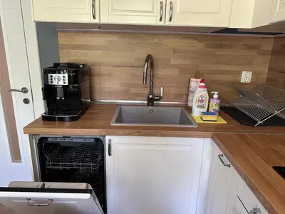 a kitchen with a sink and a microwave at Romantic City Central Apartment in Varna City