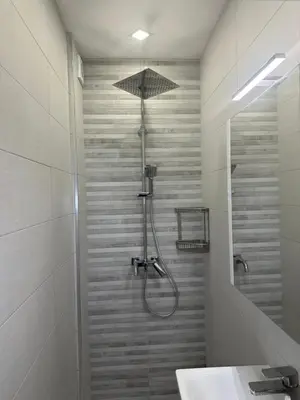 a bathroom with a shower and a sink at Romantic City Central Apartment in Varna City