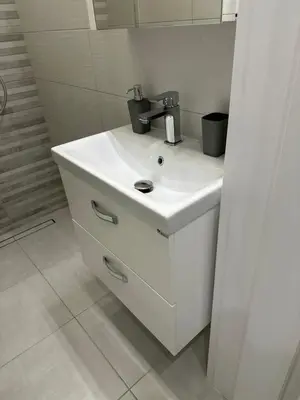a white sink with a faucet in a bathroom at Romantic City Central Apartment in Varna City