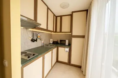 a small kitchen with a sink and a counter at Sunny Beach Victoria Penthouse in Sunny Beach