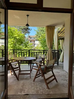 a patio with a table and chairs on a balcony at Niko's Apartment in Sozopol