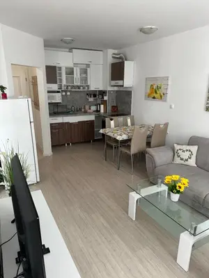 a living room with a couch and a table at Apartament Diana in Pomorie