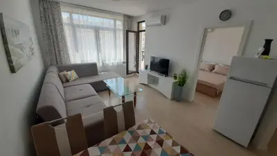 a living room with a couch and a refrigerator at Apartament Diana in Pomorie