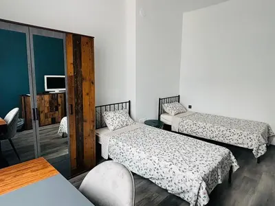 a small room with two beds and a tv at Apartment Black Sea Center 1 in Varna City