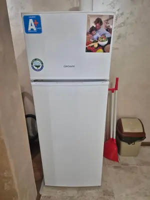 a white refrigerator with a picture on the top of it at Делукс Апарт Вергиеви in Burgas City