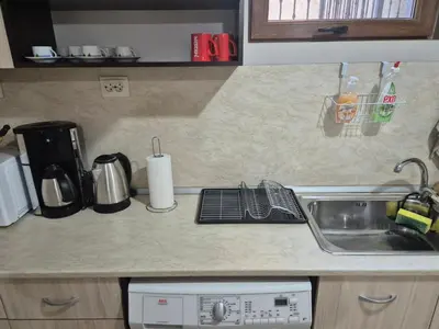 a kitchen counter top with a sink and a sink at Делукс Апарт Вергиеви in Burgas City