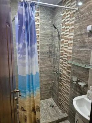 a bathroom with a shower and a sink at Делукс Апарт Вергиеви in Burgas City