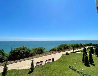 a park with benches and the ocean in the background at Fort Noks Panorama in Elenite