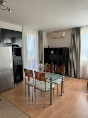 a kitchen and dining room with a glass table and chairs at Fort Noks Panorama in Elenite