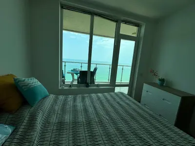 a bedroom with a bed with a view of the ocean at Stunning seaview - 50m to the beach in Byala