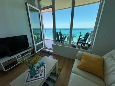 a living room with a couch and a view of the ocean at Stunning seaview - 50m to the beach in Byala