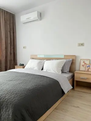 a bedroom with a bed with a black blanket at New and stylish apartment Tuthon in Pomorie