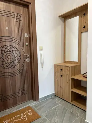a bathroom with a wooden door and a mirror at New and stylish apartment Tuthon in Pomorie