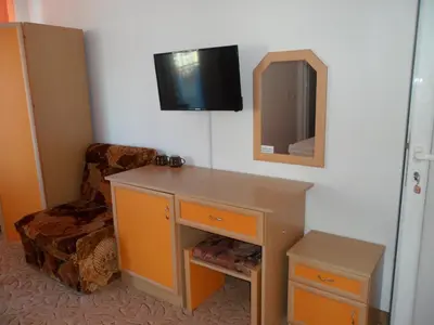 a room with a desk and a mirror and a chair at Sianie Guest House in Ravda