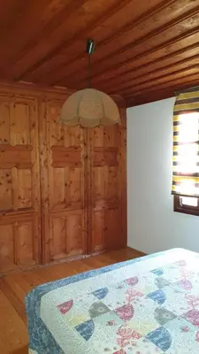 a bedroom with a bed and a wooden ceiling at Вила Мила in Tsarevo