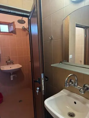 a bathroom with a sink and a mirror at Вила Мила in Tsarevo