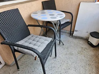 a table and two chairs and a table and a table at Стая за гости на Бургас 1 in Burgas City