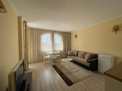 a living room with a couch and a table at Charming 1 bedroom apartment in Sunny Beach in Sunny Beach