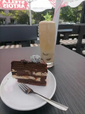a piece of chocolate cake and a drink on a table at Charming 1 bedroom apartment in Sunny Beach in Sunny Beach
