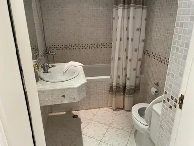 a bathroom with a sink and a tub and a toilet at Charming 1 bedroom apartment in Sunny Beach in Sunny Beach
