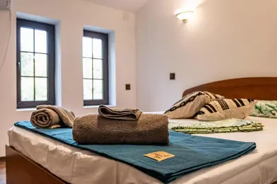 two beds with towels on top of them in a room at Seagull Apartment in Varna City