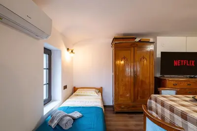 a small bedroom with a bed and a dresser at Seagull Apartment in Varna City