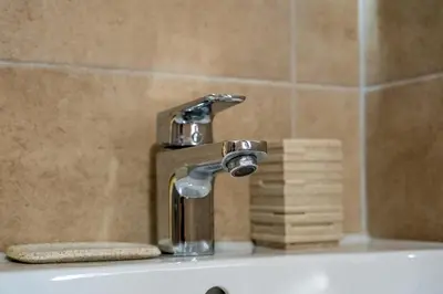 a bathroom sink with a faucet and some towels at Seagull Apartment in Varna City