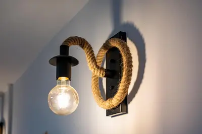 a light with a snake hanging on a wall at Seagull Apartment in Varna City