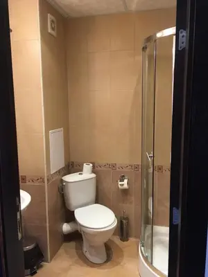a bathroom with a toilet and a sink and a shower at The Red Lozenets in Lozenets