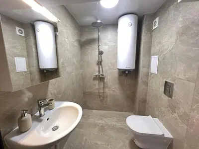 a bathroom with a sink and a toilet and mirrors at NJ bedroom in Varna City