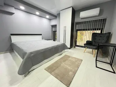 a bedroom with a bed and a desk and a chair at NJ Luxury Room in Varna City