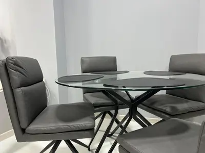a glass table and four chairs in a room at NJ Luxury Room in Varna City