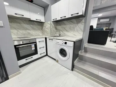 a kitchen with a washer and a washing machine at NJ Luxury Room in Varna City