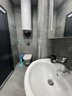 a bathroom with a white sink and a toilet at NJ Luxury Room in Varna City