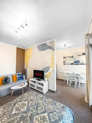 a room with a bed and a tv and a table at Burgas Residence 504 l Indoor Parking l Breakfast & SPA available in Burgas City