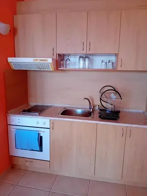 a small kitchen with a sink and a stove at Златна Дюна - до южния плаж на Несебър in Nesebar