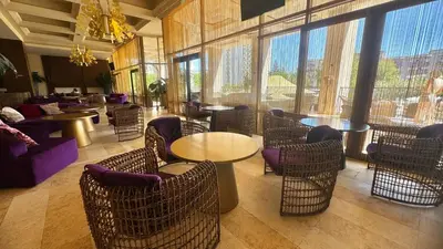 a restaurant with tables and chairs and a large window at Luxury sea view, 5star Barcelo on Beach in Sunny Beach