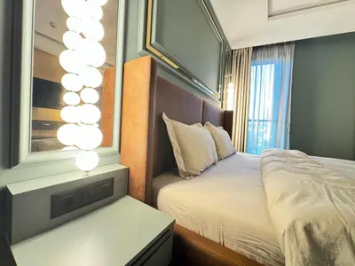 a small bedroom with a bed and a mirror at Kandinski Lux Apart in Burgas City