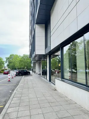 a sidewalk in front of a building with windows at Kandinski Lux Apart in Burgas City