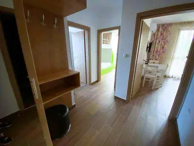 a living room with a kitchen and a dining room at Luxury Apartments in Cascadas Family Resort Sunny Beach in Sunny Beach