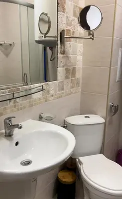 a bathroom with a sink and a toilet and a mirror at Luxury Apartments in Cascadas Family Resort Sunny Beach in Sunny Beach