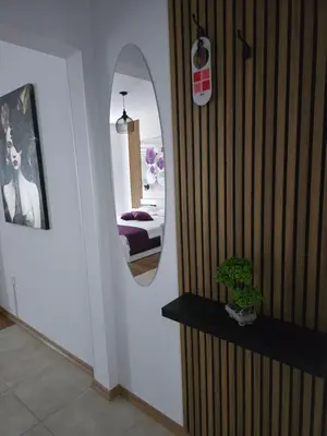 a room with a mirror and a bedroom with a bed at Stephanovy Guest House in Sozopol