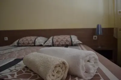 two towels sitting on top of a bed at Stella Del Mare Guest House in Kiten