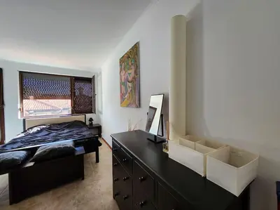 a bedroom with a bed and a dresser and a window at Bay view villas sunny beach entire villa in Kosharitsa