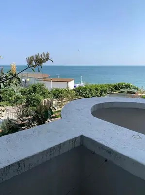a swimming pool with the ocean in the background at Вилла Яна in Sveti Vlas