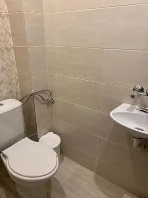 a bathroom with a toilet and a sink at Вилла Яна in Sveti Vlas
