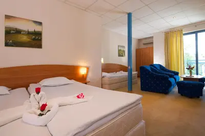 a hotel room with a bed with towels on it at Paloma - in the center of the city in Sunny Beach