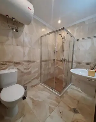 a bathroom with a shower and a toilet and a sink at Уютно студио до морето - апартаменти 25 и 26, топ локация - Cozy Studio by the Sea - Apartments 25 and 26 Top Location in Sveti Vlas