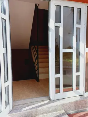 an open glass door with a staircase in the background at Guest Apartment Rusalka in Sveti Vlas